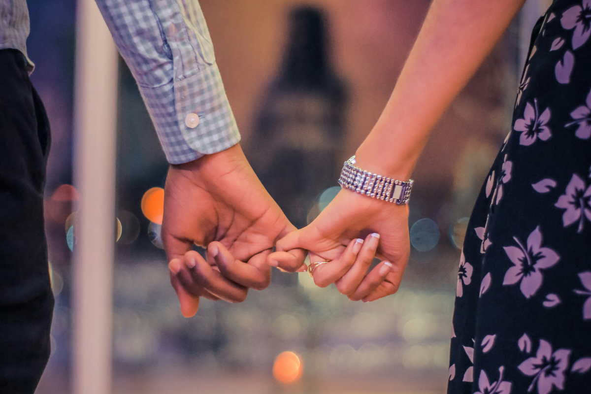 photograph of two hands holding fingers